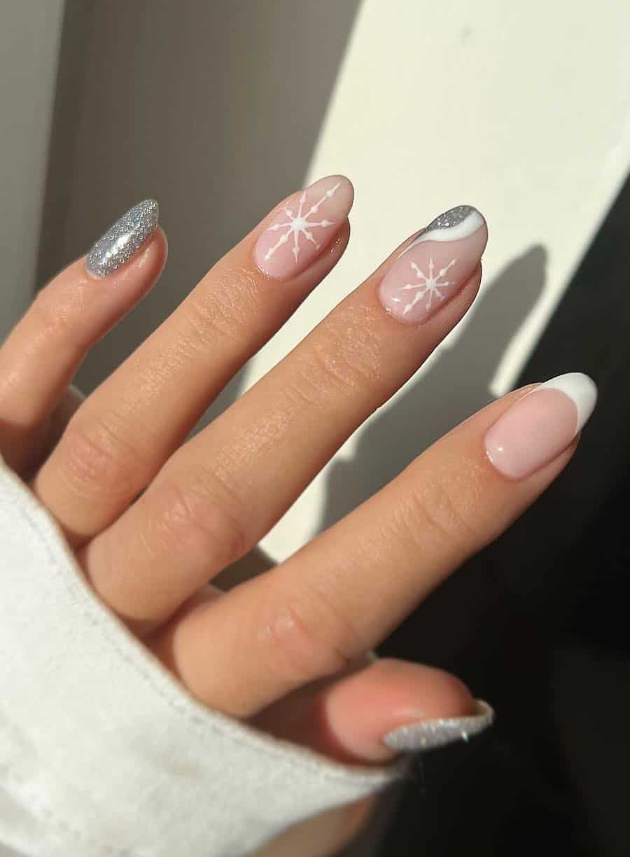 short nude round nails with white and silver glitter waves, tips, and snowflakes