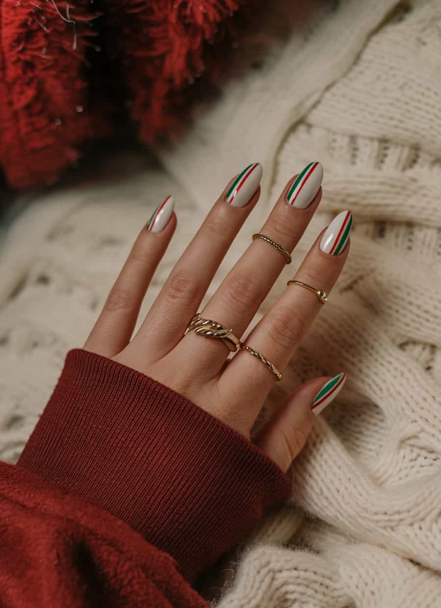 medium white almond nails with red and green vertical accent stripes