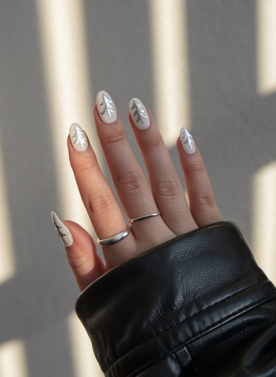 short round white nails with silver pine tree designs