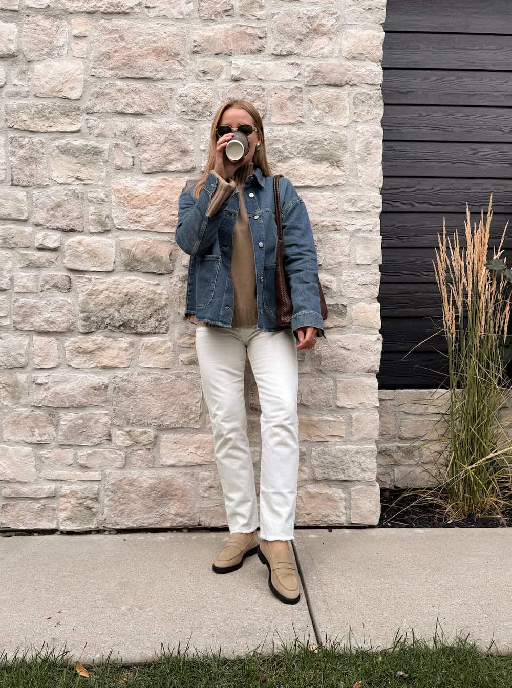 Christal wearing white jeans with a denim jacket and loafers.