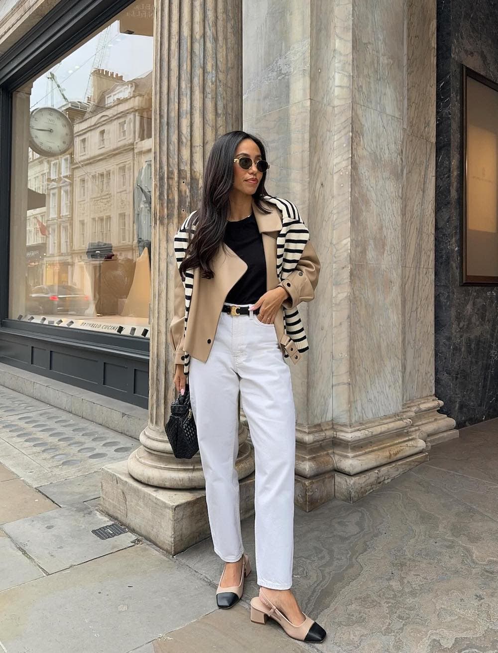 Woman wearing white jeans, a black tee, a cropped jacket and Mary Jane block heels.