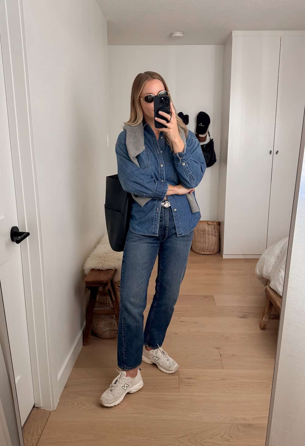 Christal wearing jeans, a denim shirt and New Balance sneakers.