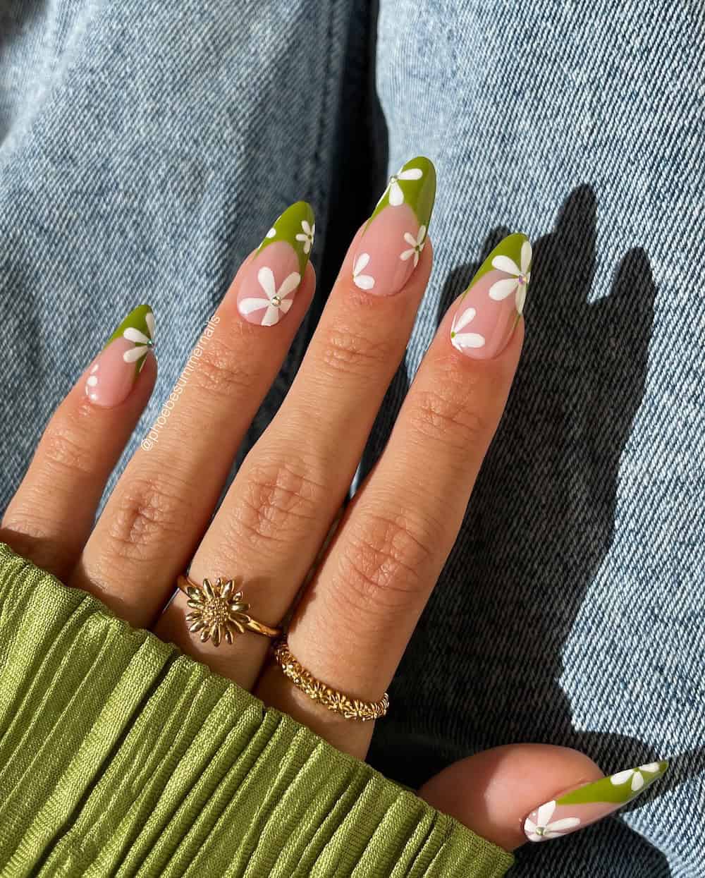 nude almond nails with olive green tips and white florals with gems