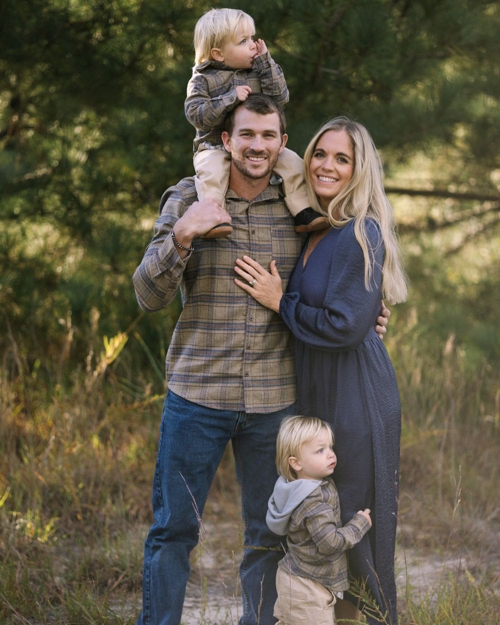 winter family photo outfits featuring green and navy tones and plaid
