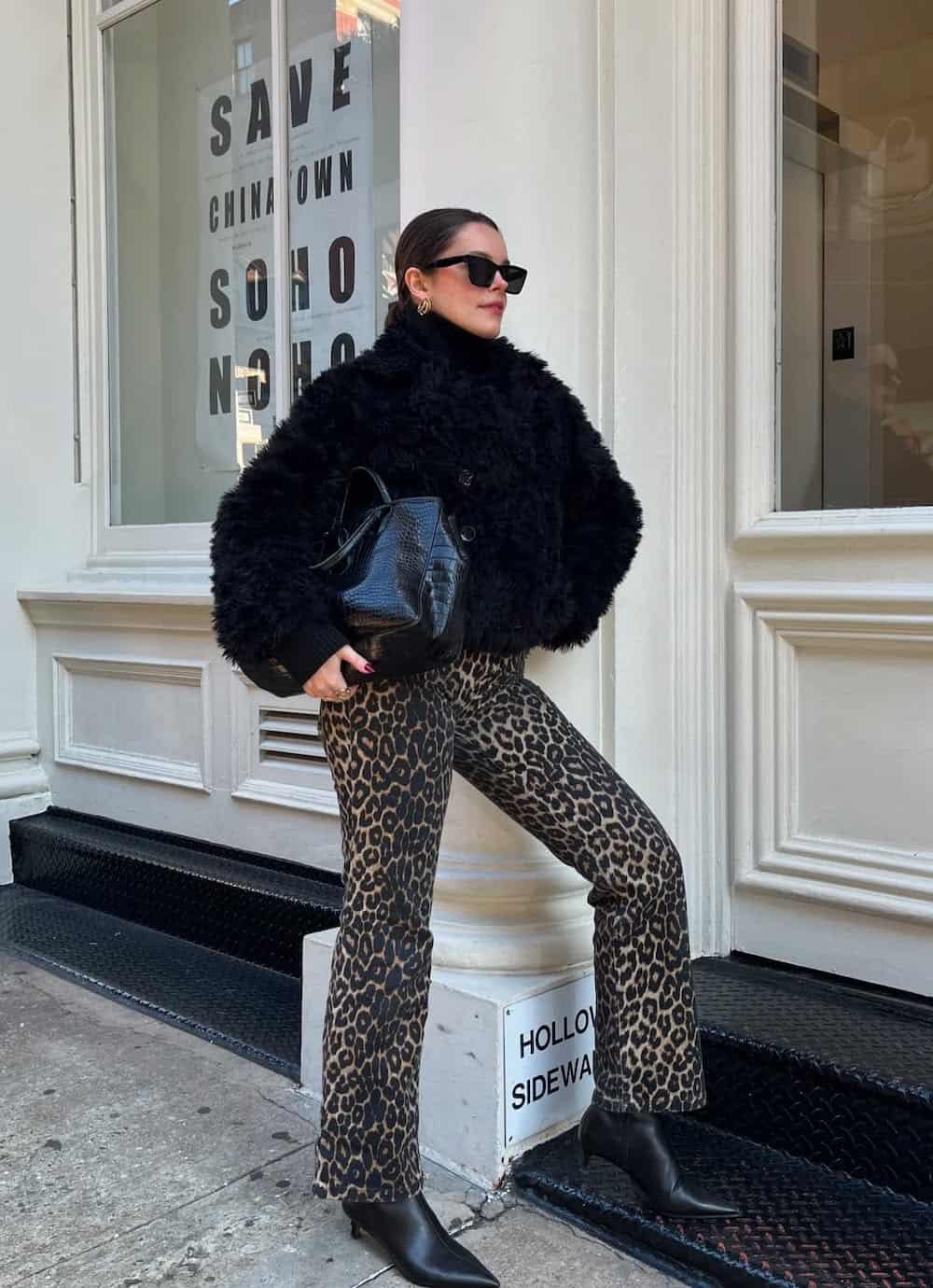 winter boots outfit with black faux fur coat and cheetah print jeans