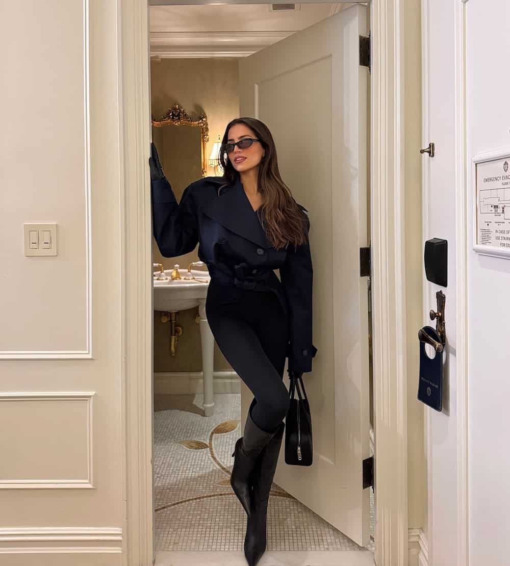 winter boots outfit with black leggings, boots, and cropped coat