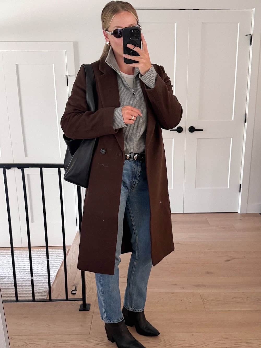 winter boots outfit with light denim, half zip, and long coat