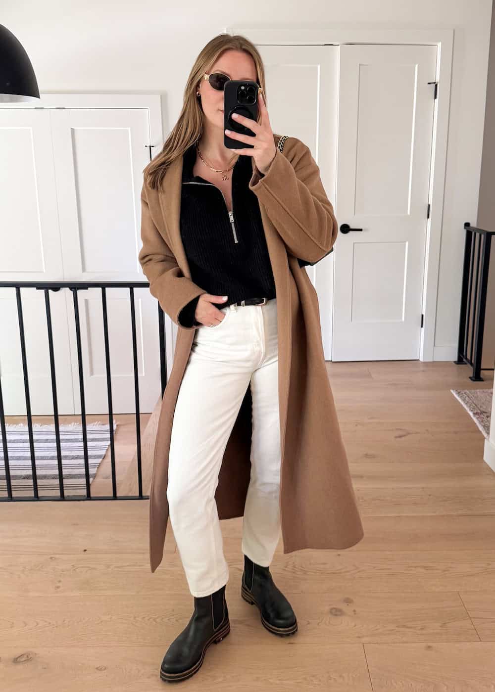 winter boots outfit with white jeans, chelsea boots, and a long wool coat