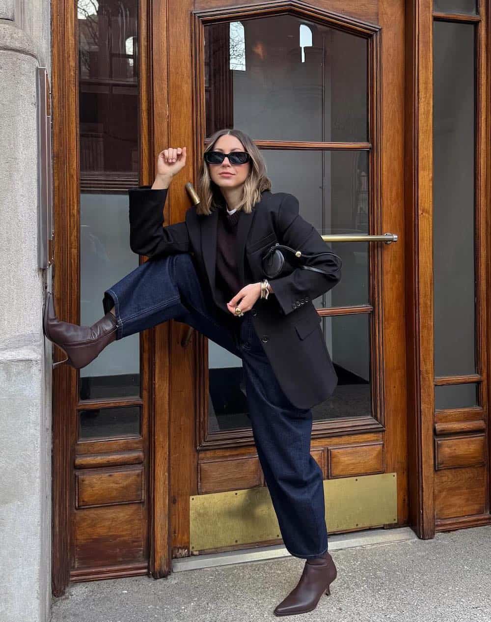 winter boots outfit with wide-leg jeans, brown boots, and blazer